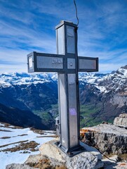 Summit cross on the Tristli summit next to the Schilt mountain above Glaurs. High quality photo