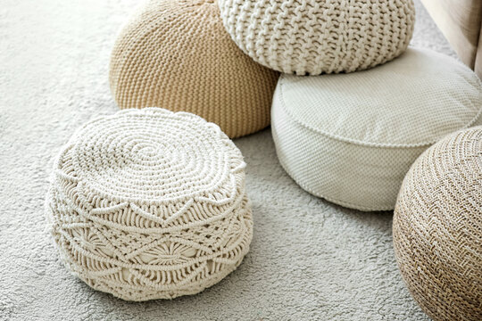 Different poufs on carpet in living room