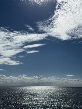 Amazing sky clouds over glittering sea.