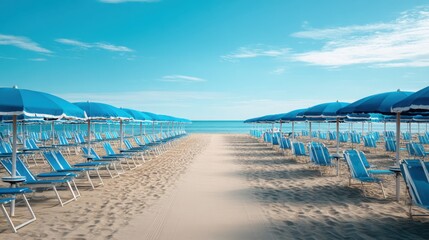 Obraz premium Rows of blue parasol and beach chair on sandy beach. Scenic coastal seascape for summer holiday and travel concept. Leisure outdoor resort.