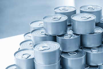 The piles of tinned can food in the blue tone scene.