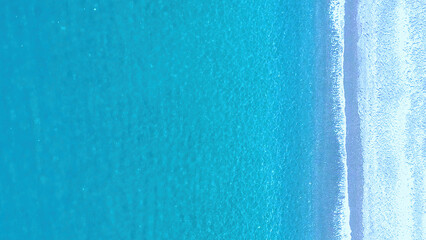 Serene Turquoise Ocean and Sandy Beach Under Bright Sunlight During Daytime Hours