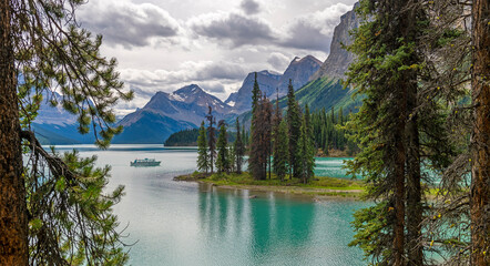 Spirit Island panorama with excursion boat and Maligne Lake, Jasper national park, Canada.