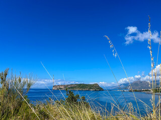 Scenic View of a Tranquil Island Surrounded by Blue Waters and Lush Greenery Under a Clear Sky