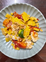 Fresh prepared asian spicy som tam corn salad with vegetables on local market in Bangkok. Traditional thai cuisine made of fresh ingredients.