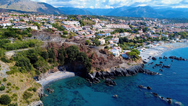 Scenic Coastal View of a Vibrant Hillside Town Near the Beach in Summer With Clear Blue Waters and Mountains in the Background. Scalea, Calabria, Italy