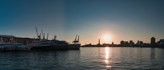 harbor with lighthouse of Genoa at sunset in Italy