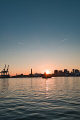 harbor with lighthouse of Genoa at sunset in Italy