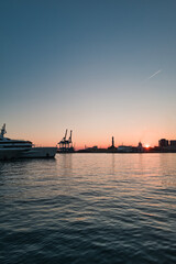 harbor with lighthouse of Genoa at sunset in Italy