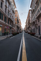 Via Roma in the city of Genoa under a blue sky in the morning