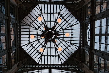 glass and steel ceiling with chandelier from below in the city of Genoa