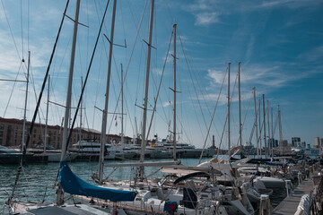 Port of Genoa with sailing ships and the lighthouse in the background