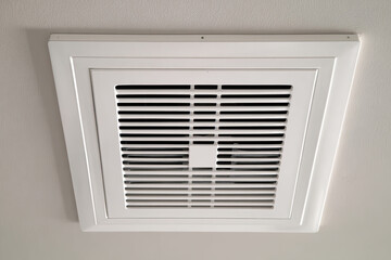 White ceiling ventilation grille with rectangular diffuser and smoke catch. close up photo
