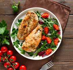 Baked chicken breast and vegetable salad on plate