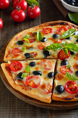 Piece of pizza with tomato and olives