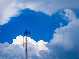 Obraz premium Pole reaching towards clouds in the blue sky over Sweden during a calm day