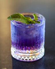 Butterfly Pea Flower Cocktail with Mint Garnish on Bar Counter