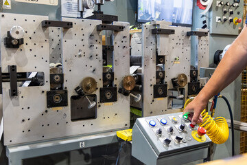 Technician Operating Industrial Machine in Manufacturing Facility