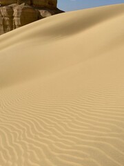 Majestic Sand Dune Rising under Bright Blue Sky