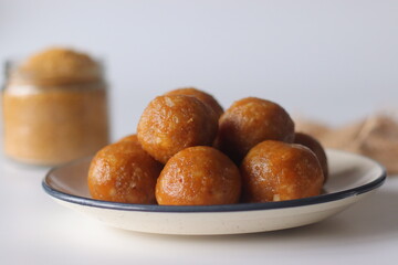 Jackfruit laddus on a rustic burlap backdrop, made with pureed jackfruit, raw sugar and coconut