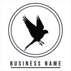 Fototapeta premium Black bird silhouette flying inside circle falcon hawk