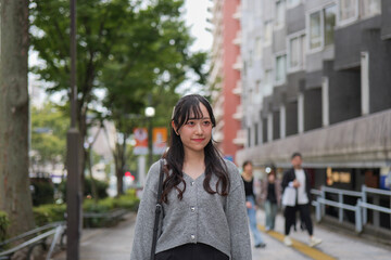 Fototapeta premium Urban portrait of smiling woman on Harajuku street