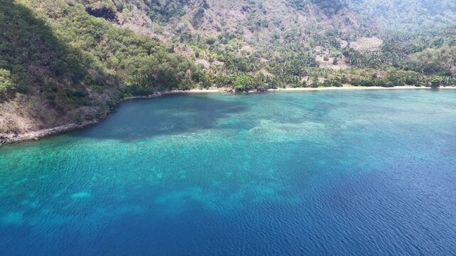 A small ship lies off the coast of Pulau Romang, east of Alor, Indonesia. This scenic region of the Lesser Sunda Islands harbors incredible marine biodiversity and is a popular diving area.