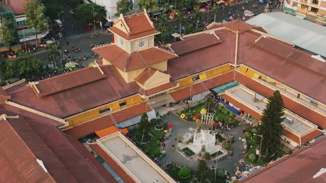 Aerial 4K Drone View of Historic Binh Tay Market Clock Tower, Ho Chi Minh City's Chinatown Landmark
Cholon Chinatown district, showcases a rare blend of traditional Chinese design elements with French