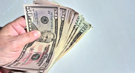 American or US dollars in form of a bunch of fifty and twenty dollar bills - money in the USA