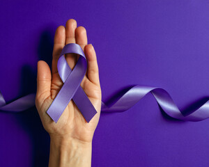 Hopeful hand cradles purple awareness ribbon symbolizing support and unity against disease on vibrant background