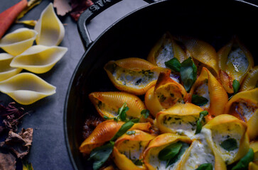 Traditional Italian conchiglioni pasta beautifully arranged on a rustic background. A classic taste of Italy captured in a warm and inviting food scene — perfect for authentic cuisine, restaurant menu