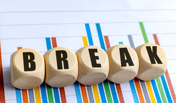 BREAK word on wooden round blocks with colorful bar chart background