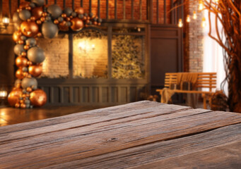 Empty wooden table in room decorated for Christmas. Space for design