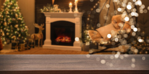 Empty wooden table in room decorated for Christmas, bokeh lights. Space for design