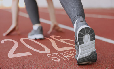 New 2026 Year. Woman in starting position at stadium, closeup. Numbers and word Start on road