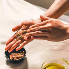Close-up of Masseuse’s Hands Covered with Oil and Scrub During Spa Body Treatment