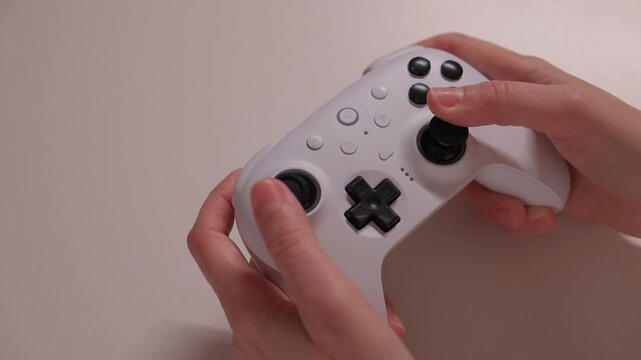 A Close Up View of Hands Firmly Gripping a Video Game Controller for an Immersive Experience