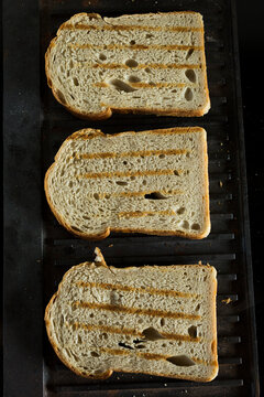 Three Slices of Toasted Bread with Grill Marks on a Panini Press