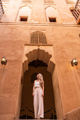 Woman traveling in oman admiring traditional arabic architecture