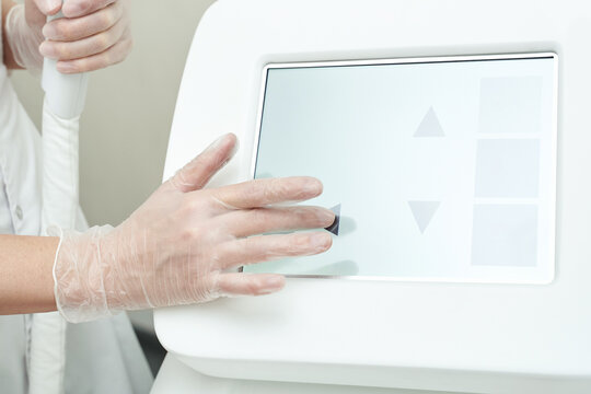 Caucasian female adult operating medical device with touchscreen interface for healthcare procedures. - Powered by Adobe