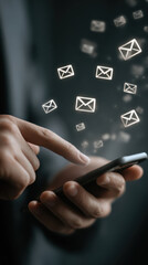 Hands holding smartphone checking email inbox with glowing icons