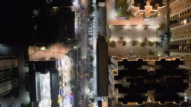 aerial drone forward moving shot straight down showing decorated buildings, streets, shopping malls on the eve of diwali with colorful lights, shot in Delhi, Mumbai