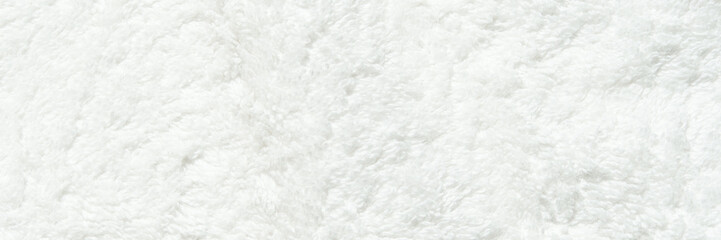 Soft white fluffy towel surface texture background with plush fabric detail.