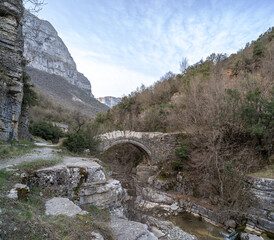Old small arched stone bridge of Lakou or Loli's, between the micro and megalo Papingo villages during spring