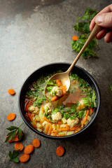 Classic meatball soup with potatoes,  carrot and greens.