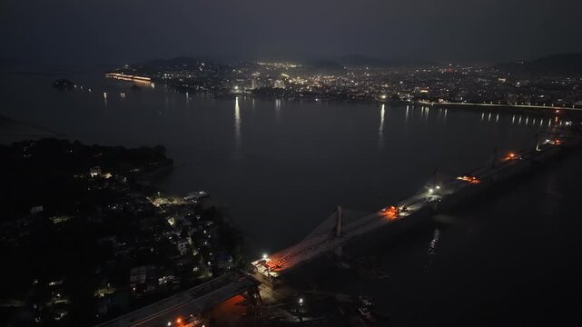 Beautiful aerial night view of the city next to mighty Brahmaputra river