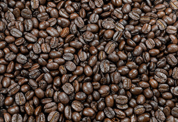 Roasted coffee beans, Close-up of freshly mixed site arabica coffee beans in dark roast, with dark brown color, conveys rich taste and aroma. background to advert coffee products, coffee shops.