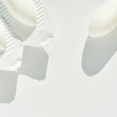 White suppository blister pack on light background with shadows and minimalist design.