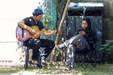 Dad playing guitar in the backyard with the family