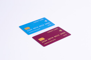 Blue and Red Fictional Credit Cards on White. Symbolizing varied banking products, secure online payment, and contactless options.
